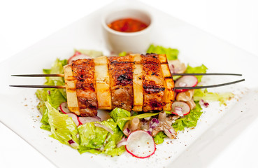 A plate with meat dishes, kebabs, bishtex, sauces and various croutons.