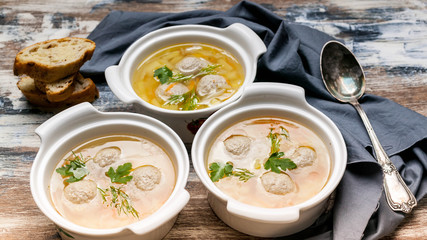 Three plates of vegetable soup with meatballs. Cabbage, potatoes, carrots and meatballs.