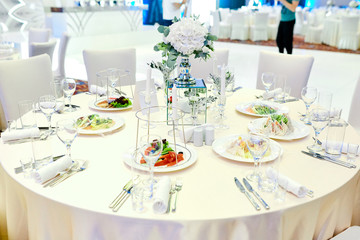 table setting with cutlery and glass and food on the table