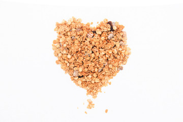 Heart from crispy muesli dry Breakfast isolated on white background selective focus, top view