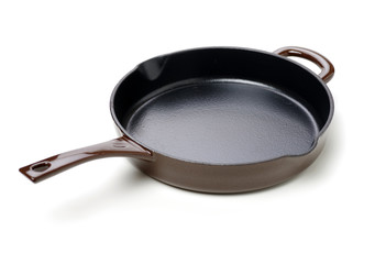 Round cast iron griddle pan on white background