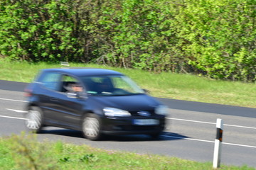 blurred car passing by on a sunny day in europe
