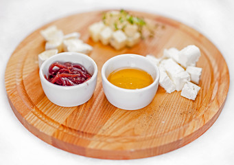 Dish with different types of cheese and sauces. Cheese torte with sauces.