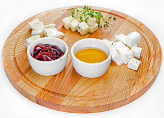 Dish with different types of cheese and sauces. Cheese torte with sauces.