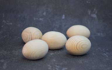 Decorative wooden Easter eggs in a wicker plate basket