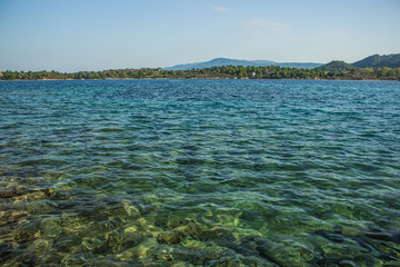 shallow water sea bay surrounded by park outdoor forest island shoreline