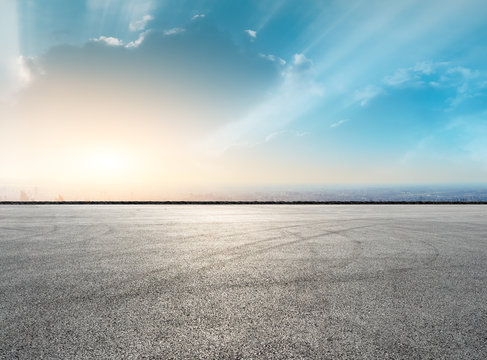 Shanghai city skyline and asphalt race track ground at sunrise,high angle view