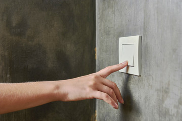 Female hand, to turn off the light, switch, front view