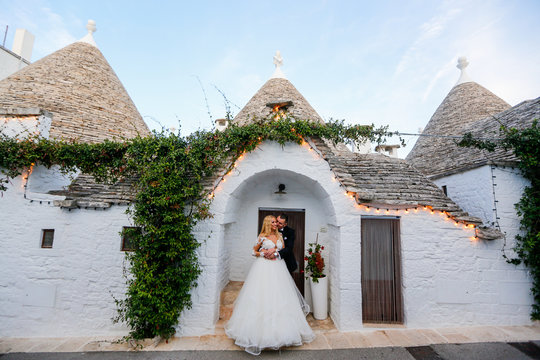 Happy beautiful wedding couple posing outdoor in roamntic city