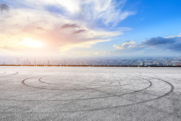 Fototapeta premium Shanghai city skyline and asphalt race track ground at sunrise,high angle view