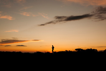 Fototapeta na wymiar Happy time on sunset and silhouette human