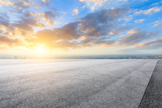 Shanghai city skyline and asphalt race track ground at sunrise,high angle view