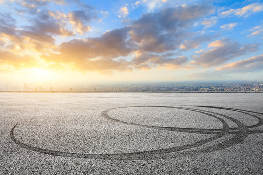 Shanghai city skyline and asphalt race track ground at sunrise,high angle view