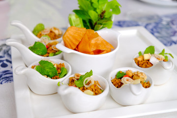 Thai appetizer, fired pork with herbs served on spoon 