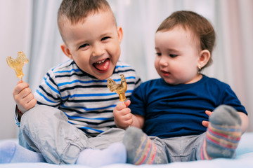Brother and sister eat lollipops in the form of a cock