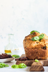 Savoury loaf cake with dried tomatoes, mozzarella and basil. Selective focus.