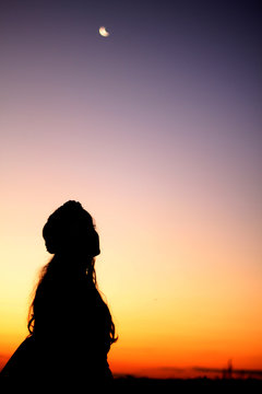 silhouette of woman at sunset