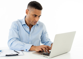 Attractive happy handsome african american businessman working on laptop computer on desk at office