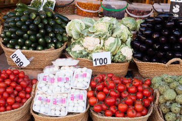 vegetables and fruits in wicker baskets on counter of greengrocery