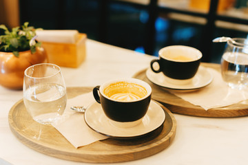 Fresh cappuccino on table in coffee shop