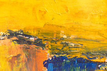 Texture of bright strokes of cracked yellow and blue paint on the wall surface. Empty background.