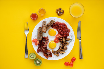 English breakfast on a yellow background. Awakening concept