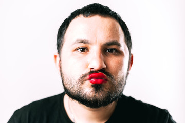 Obraz premium portrait of Bearded man with painted lips posing
