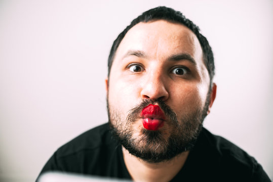 portrait of Bearded man with painted lips posing