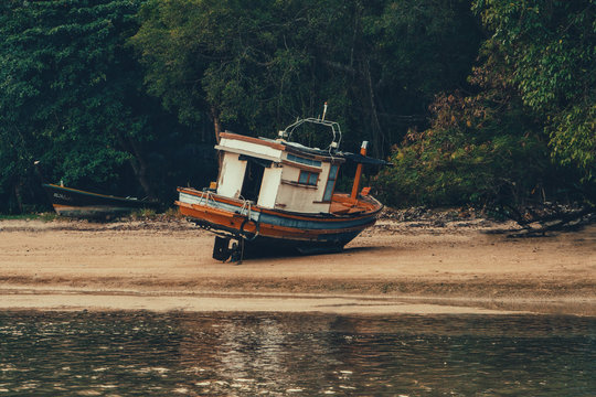 Wooden fishing boat on a sandy beach