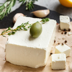 Cubes of feta cheese and spices on board