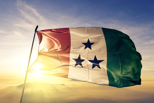 Ngabe-Bugle comarca of Panama flag waving on the top sunrise mist fog