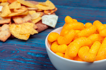 Differnt Types of Junk food, salty-sticks, salty-crackers on wooden table in still-life