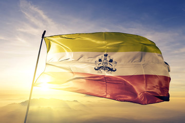 Karnataka state of India flag waving on the top sunrise mist fog