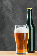 Single beer glass close up on dark stone background