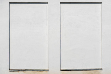 weathered white stucco wall with a stucco frame.