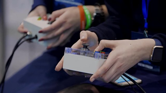 Boy hands holding remote controlling robot.