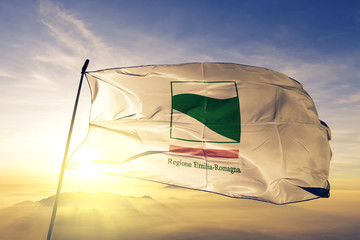 Emilia-Romagna region of Italy flag waving on the top sunrise mist fog
