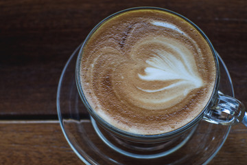 Cappuccino coffee on old wooden table and roasted coffee beans - Image