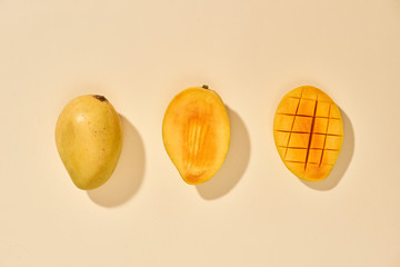 Fresh and beautiful mango fruit with sliced diced mango chunks on pastel background, copy space(text space), blank for text, top view.