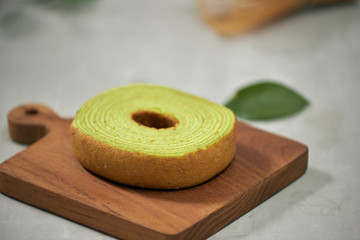 Close up on green matcha Baumkuchen Japanese roll cakes, selective focus