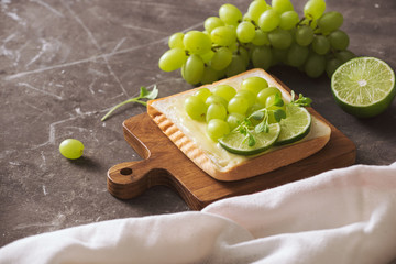 Perfect gourmet appetizer. Toast bread with green salads on top. Bread, vegetable and fruit. Diet concept.