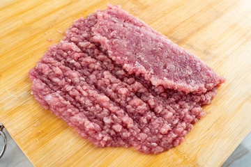 Minced pork puree on bamboo cutting board