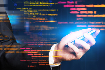 Hand with smartphone, lines of code