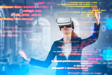 Young woman in VR headset working with code