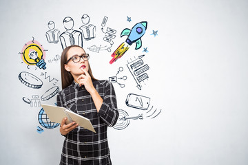 Young woman with copybook thinking about startup