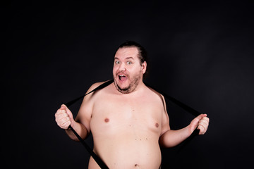 Funny fat man. Black background.