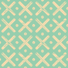 Soft yellow polka dots and crosses with textured chalk effect. Bright seamless geometric vector pattern on mint green background. Great for wellness, beauty products, stationery, packaging, giftwrap