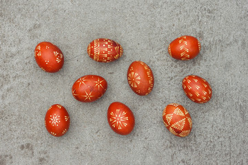 Ukrainian painted easter eggs of red color on the background of a gray concrete surface