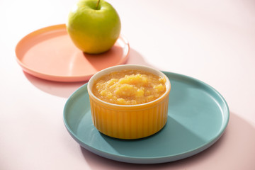 Natural baby food concept. Bowl of apple baby puree.