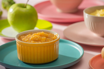 Natural baby food concept. Bowl of apple baby puree.